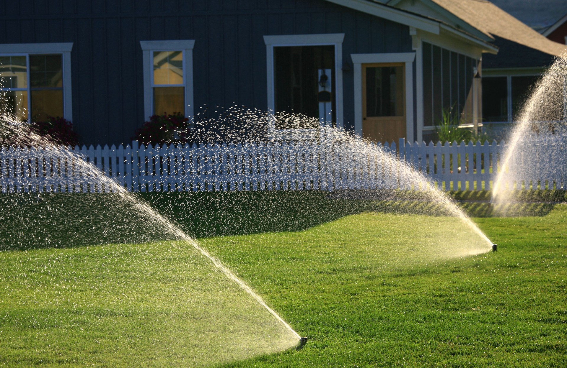 Sprinkling of water keeps a beautiful green lawn.